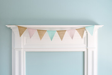 Mantel decorated with pastel flag bunting.