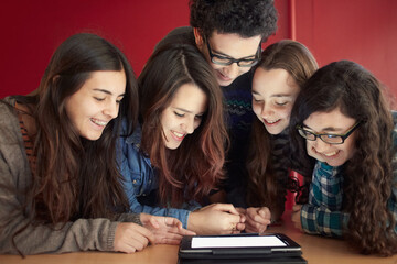 Group of teenagers working with a digital tablet