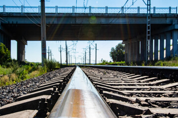 Railway rails pillars, infrastructure, nature summer.