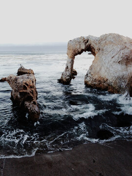 Dark Waves Under Ocean Arch