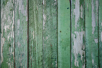 Background, texture, old wooden fence wall, peeling paint around the perimeter.