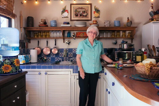 Healthy and happy 87 year old woman in her kitchen.