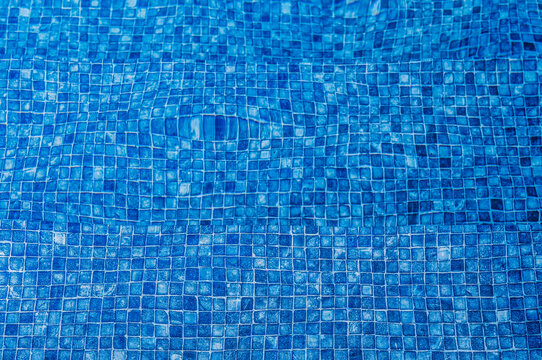 tiles underwater at the bottom of a swimming pool,
