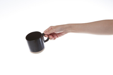 hand holding a black cup of coffee.