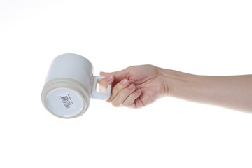 hand holding a white coffee cup.