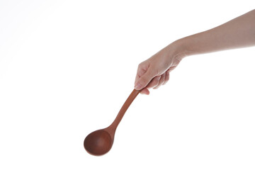 a hand holding a wooden ladle.
