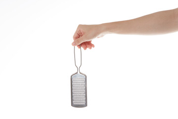 the hand holding the cheese grinder.