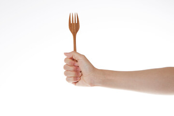 hand holding wooden fork.