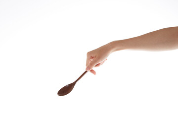 hand holding  wooden spoon. use the spoon.