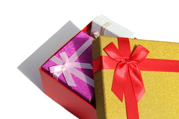 Three gift boxes of different colors stand on a white background