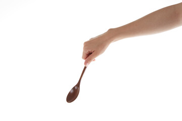 hand holding  wooden spoon. use the spoon.