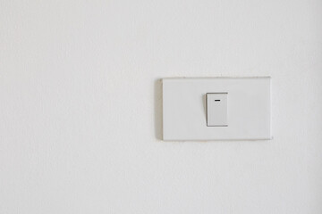 White light switch on the white wall.