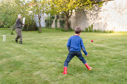 Father and son cricket match in action