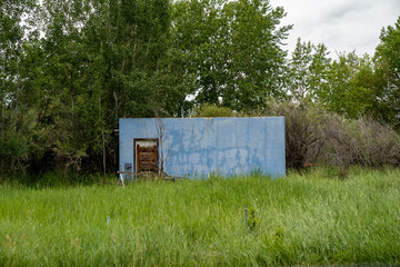 Fototapeta na wymiar Old abanonded blue building or shed, in rural Sheridan, Montana