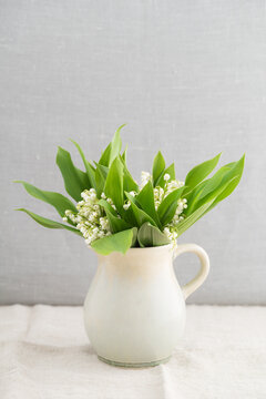 Bouquet of lilies of the valley on linen tablecloth