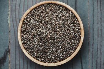 Healthy Chia seeds in a wooden bowl on the table close-up