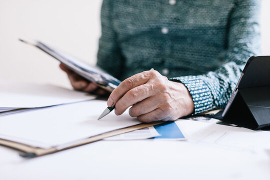 Closeup of an elderly businessman working at office.