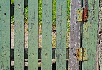 Old green gate and hinges