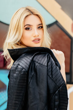 Beautiful woman with a leather jacket over her shoulder