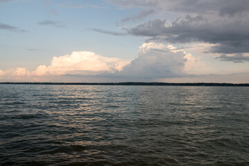 Fototapeta premium sunset over the sea during cloudy weather with vibrant and calm sky