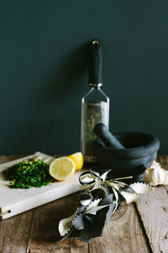 Bi-coloured pasta and the ingredients for gremolata