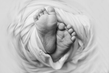 Baby's feet, fingers close up. newborn baby legs, massage concept of childhood, health care, IVF, hygiene