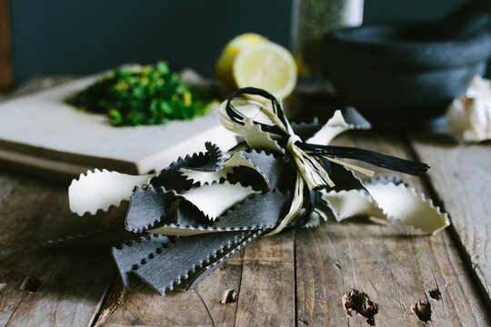 Bi-coloured pasta and the ingredients for gremolata