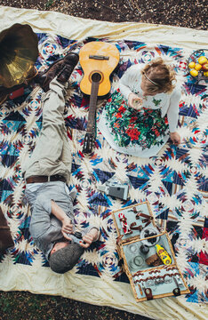 Retro Picnic - Overhead of Man Taking a Photograph of Pretty Woman Drinking Champagne