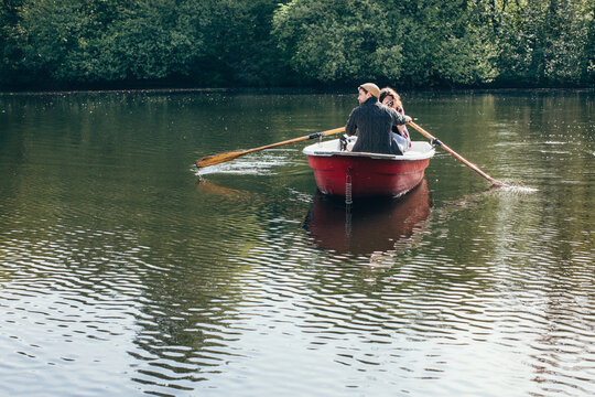 Young Couple in Rowboat - Woman Taking Photograph With Old Camera