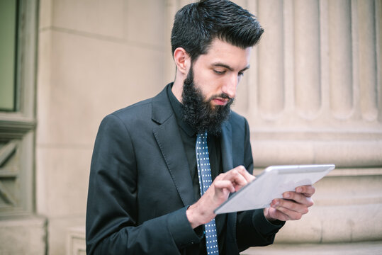 Young Hip Businessman Using Tablet Computer