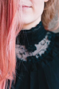 Anonymous teenage girl hiding behind her pink hair