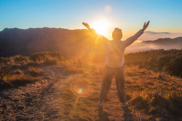 young woman standing in the mountains