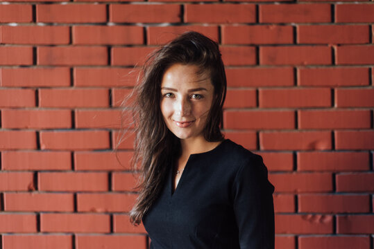 Beautiful woman portrait against the brick wall