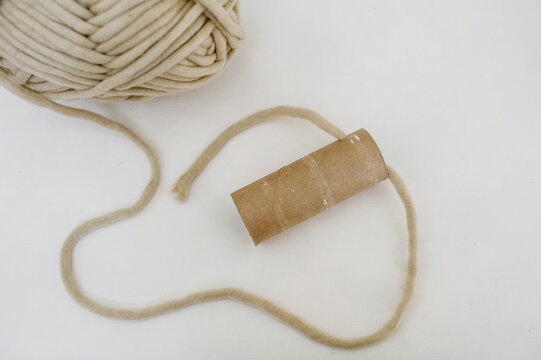 Yarn pulling through hole step for DIY binoculars
