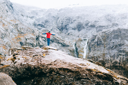 A man climbs a beautiful mountain landscape in New Zealand