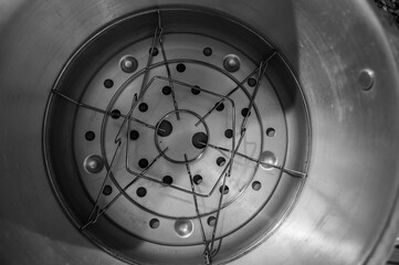 Metal basket for canning jars in the bottom of pressure cooker