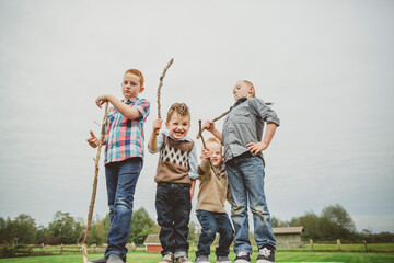 four brothers goofing around with sticks