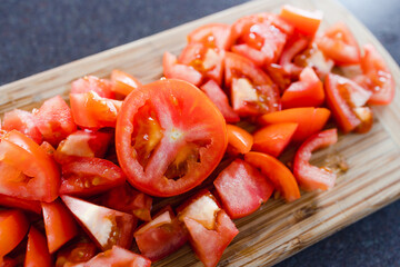 simple food ingredients, fresh raw tomatoes diced up on cutting board