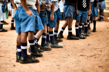 Children in uniform lined up in a boarding school before classes
