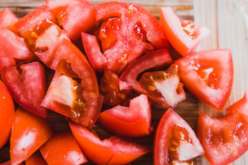 simple food ingredients, fresh raw tomatoes diced up on cutting board