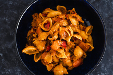 plant-based food, vegan red pesto pasta with eggplant zucchini and red pepper mix with spices