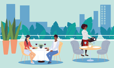 People dining in an upscale outdoor luxury restaurant and waiters taking the order