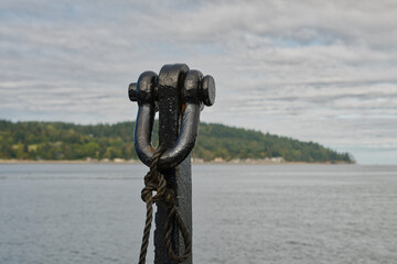 2020-09-02 ONE BLACK COLORED BOAT TIE DOWN WITH LUMMI ISLAND IN THE BACKGROUND