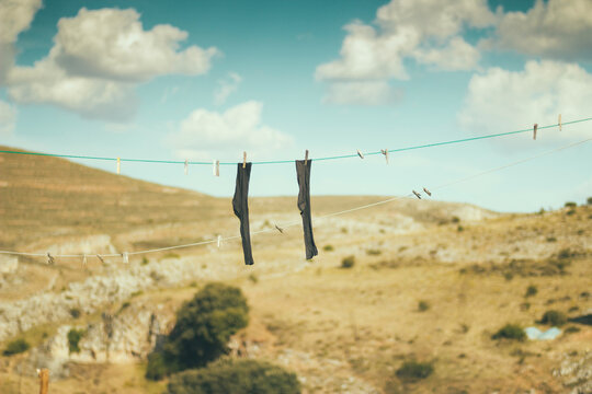 Socks hanging on a rope with pegs.
