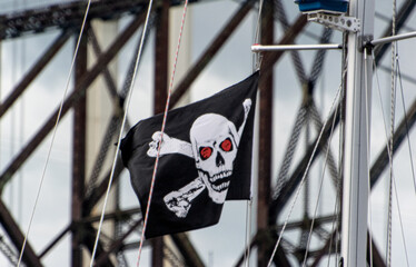 pirate flag on mast with steel beams in background