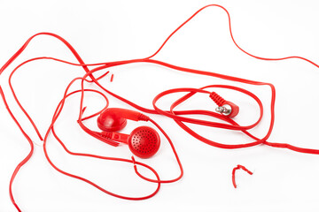 Headphones on a white background. Torn headphones. Repair of electronic devices. Broken wire.