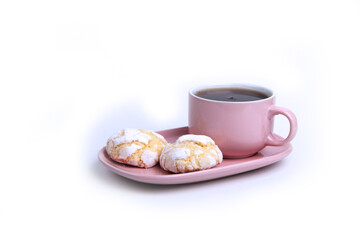 Obraz na płótnie Canvas a cup of tea on a saucer and two pumpkin cookies isolated on white background