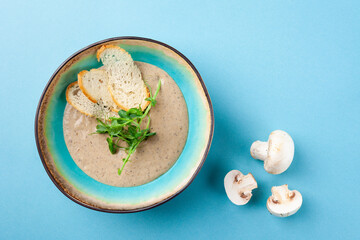Tasty creamy mashed soup puree with champignon mushrooms