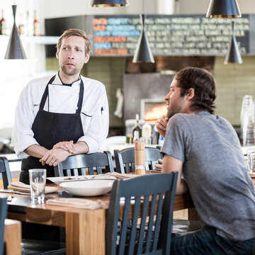 Chef and shift manager conversing after a meal