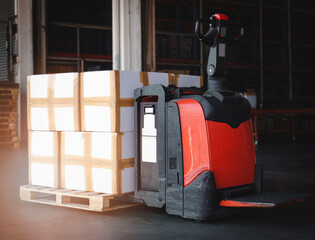 Shipment, Cargo freight, Delivery. Logistics and transportation. Electric forklift pallet jack with stack of carton boxes on pallet in warehousing.